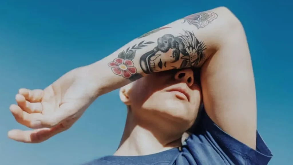 A close-up of a person's tattooed arm featuring vibrant traditional ink, highlighting the importance of using the best vitamins for skin regeneration after ink to maintain color depth and skin health.