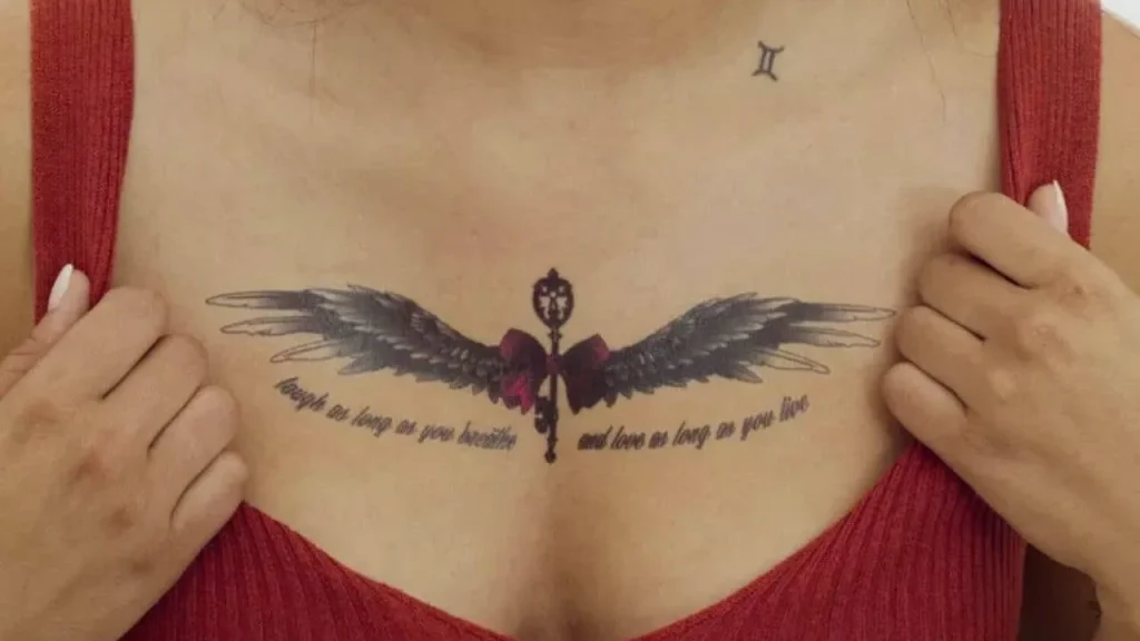 A detailed fine-line chest tattoo with script and wings showcasing the results of how to prevent tattoo blowout in fine-line art