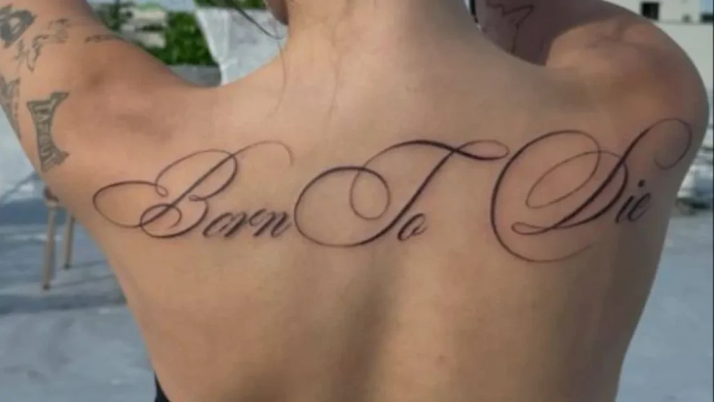 Large-scale fine-line Memorial Handwriting Tattoos featuring an elegant script design across the upper back and shoulders.