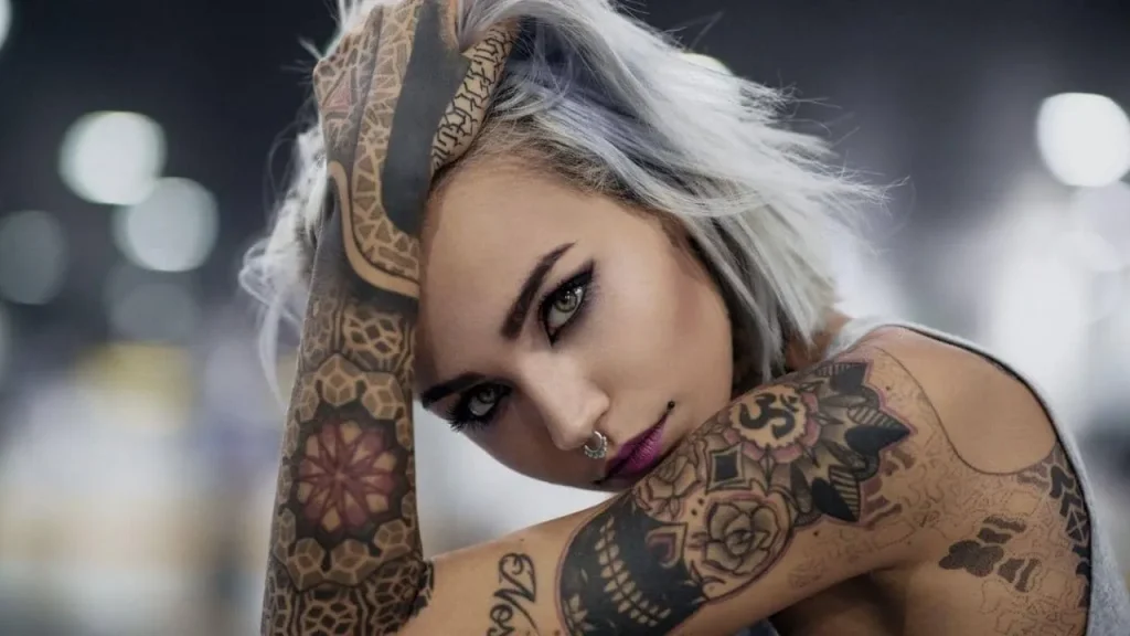 A woman with intricate sleeve tattoos showcasing the precision of AI Tattoo Prompting for Micro-Realism Designs.