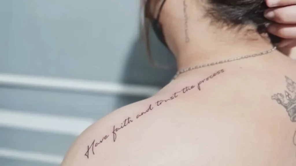 Fine-line Memorial Handwriting Tattoos featuring an inspirational script across the shoulder and upper back.
