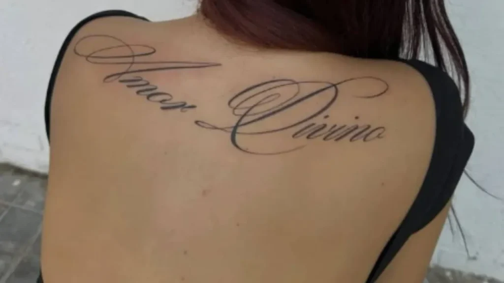 Large-scale Memorial Handwriting Tattoos featuring an elegant, flowing script across the upper back and shoulders.