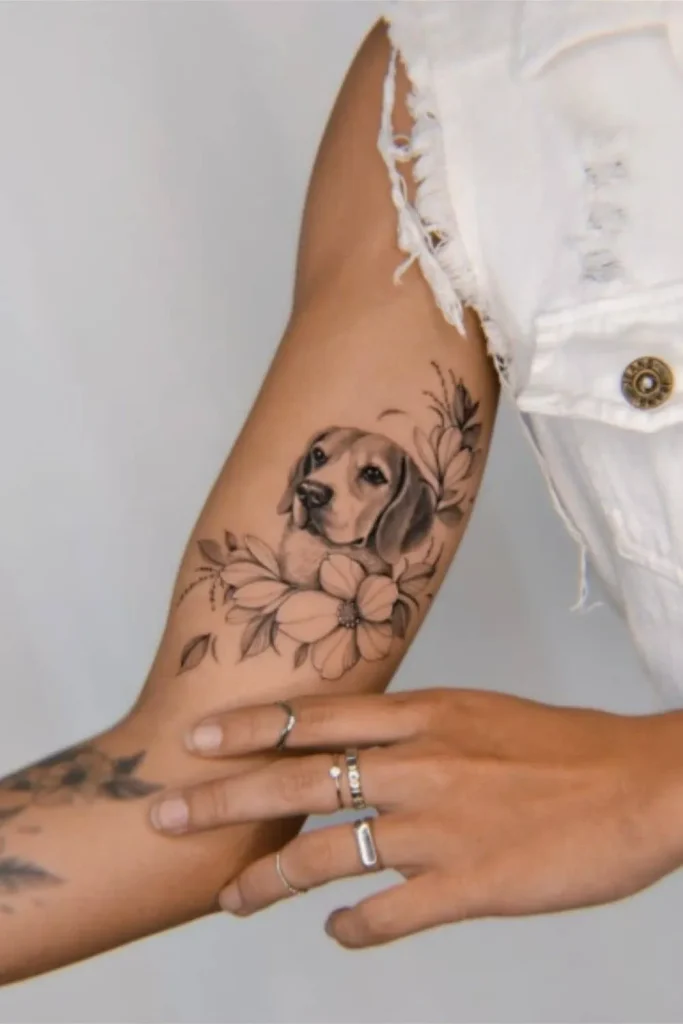 A high-resolution comparison showing a live Sphynx cat being held next to a completed Micro Realism Pet Memorial Tattoo on a thigh, featuring a crown and floral accents.