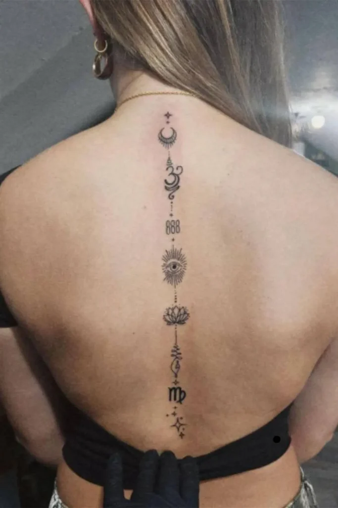 A vertical Spine Chakra Sacred Geometry Tattoo featuring minimalist celestial and spiritual symbols in a fine-line style on a woman's back.