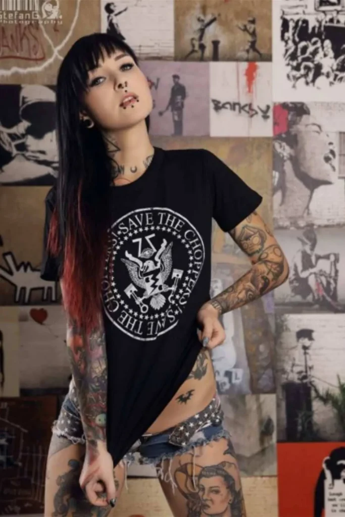 A woman with a cohesive Y2K sticker sleeve tattoo featuring a full-body patchwork collection of bold black-ink designs.